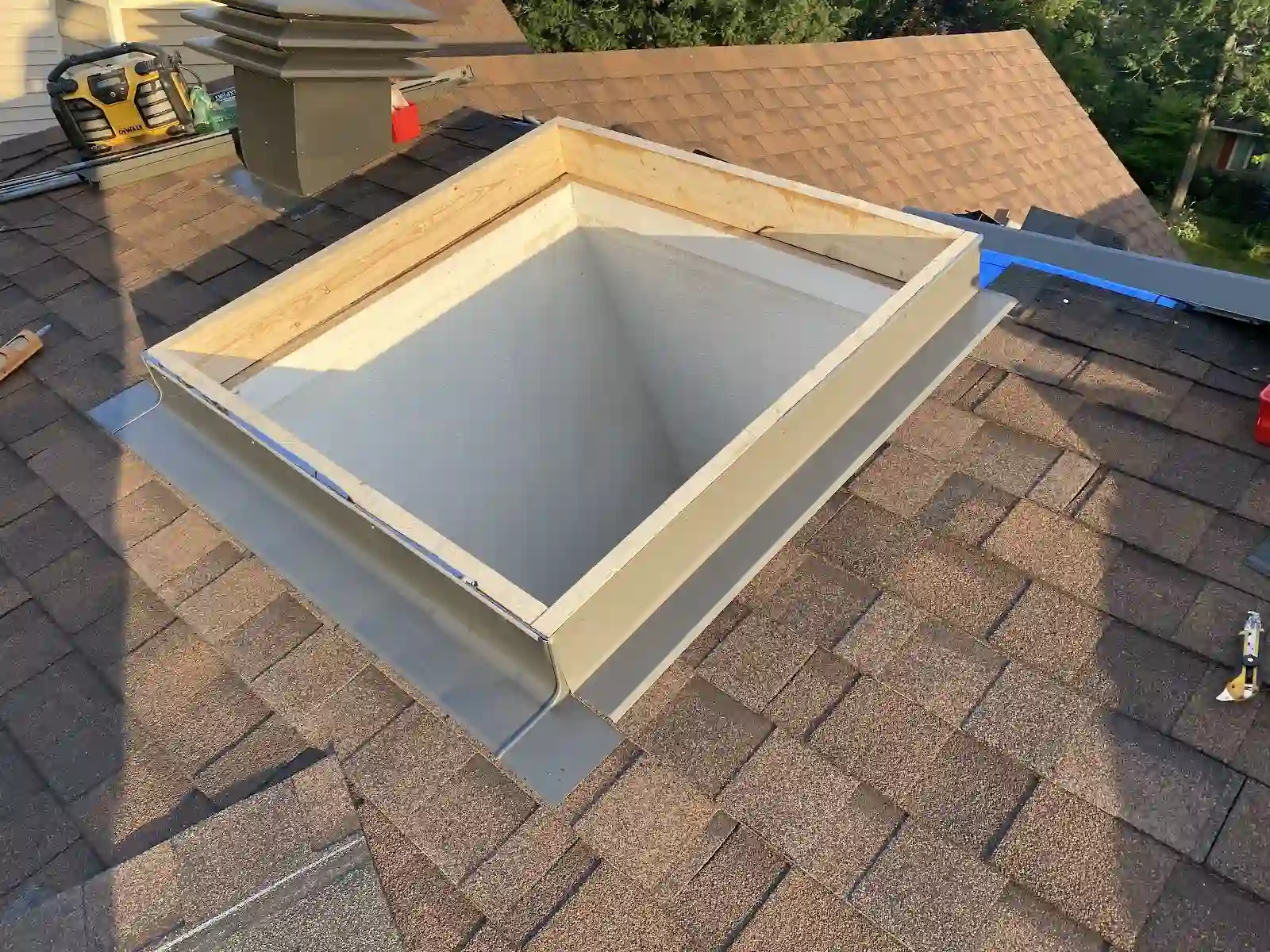 Skylight frame work on a shingled roof